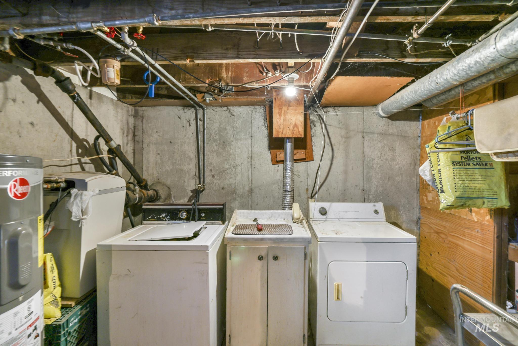 Laundry room with water heater and washing machine and clothes dryer