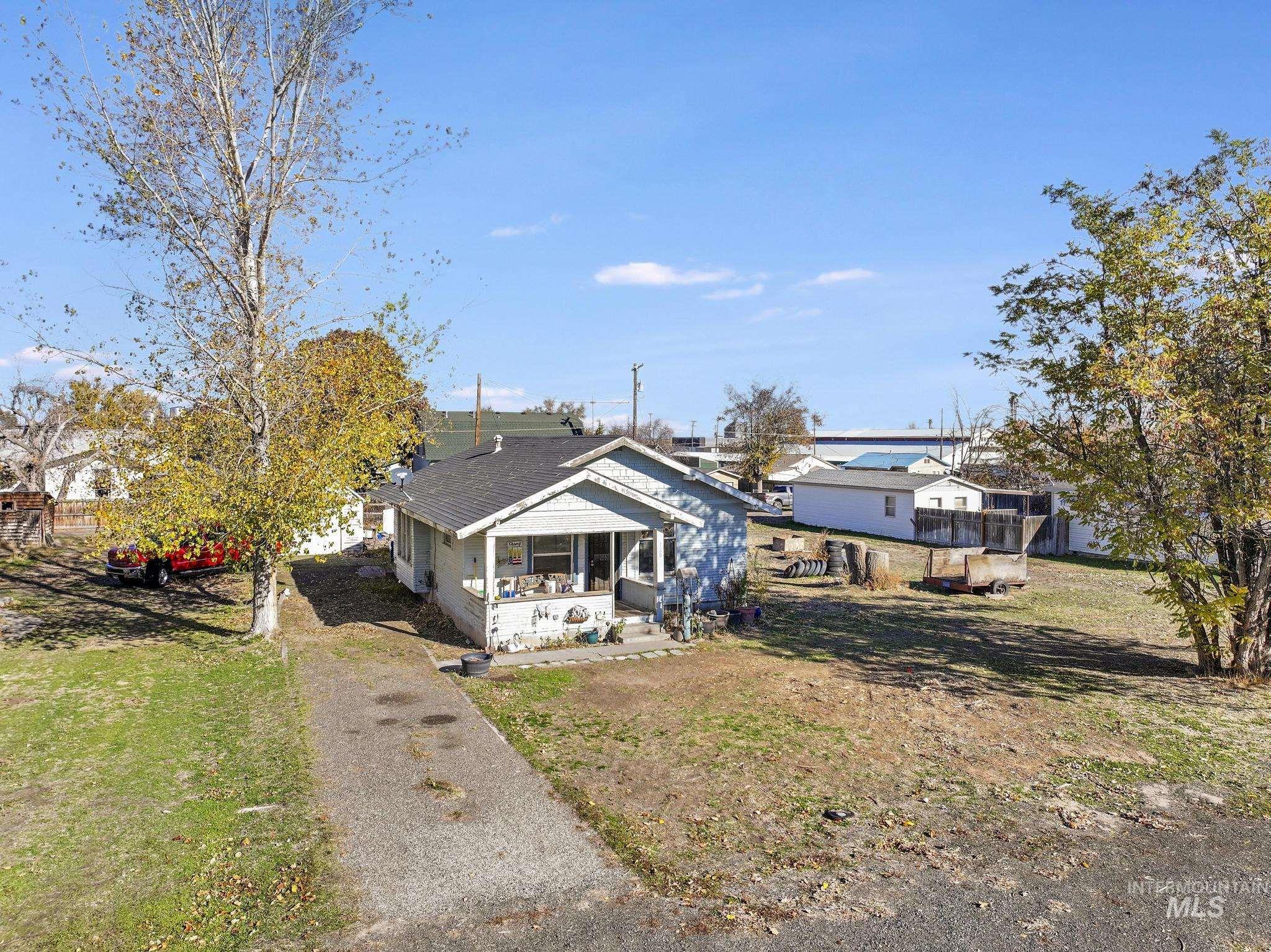 Rear view of house featuring a lawn