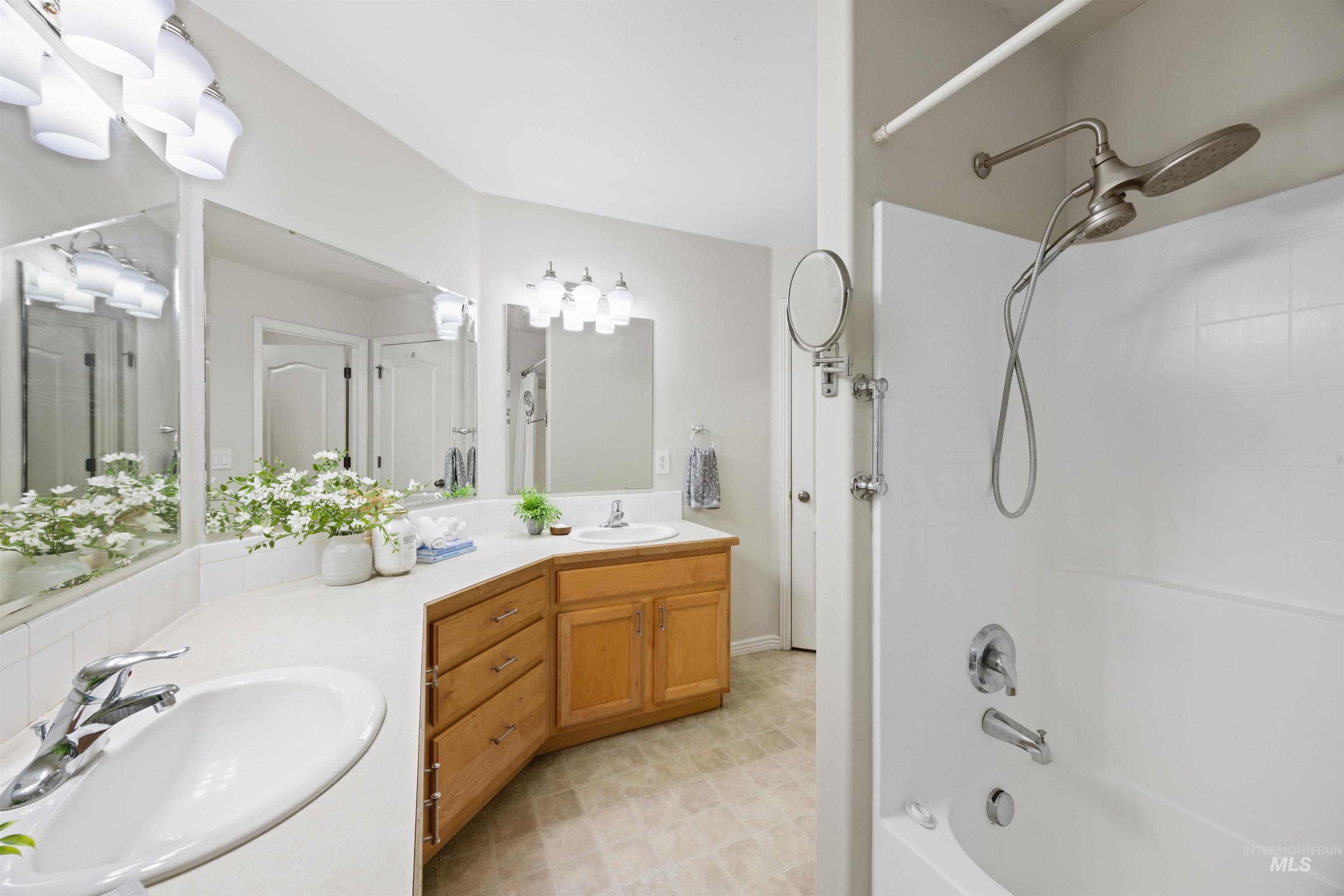 Full bathroom with shower / tub combination and double vanity
