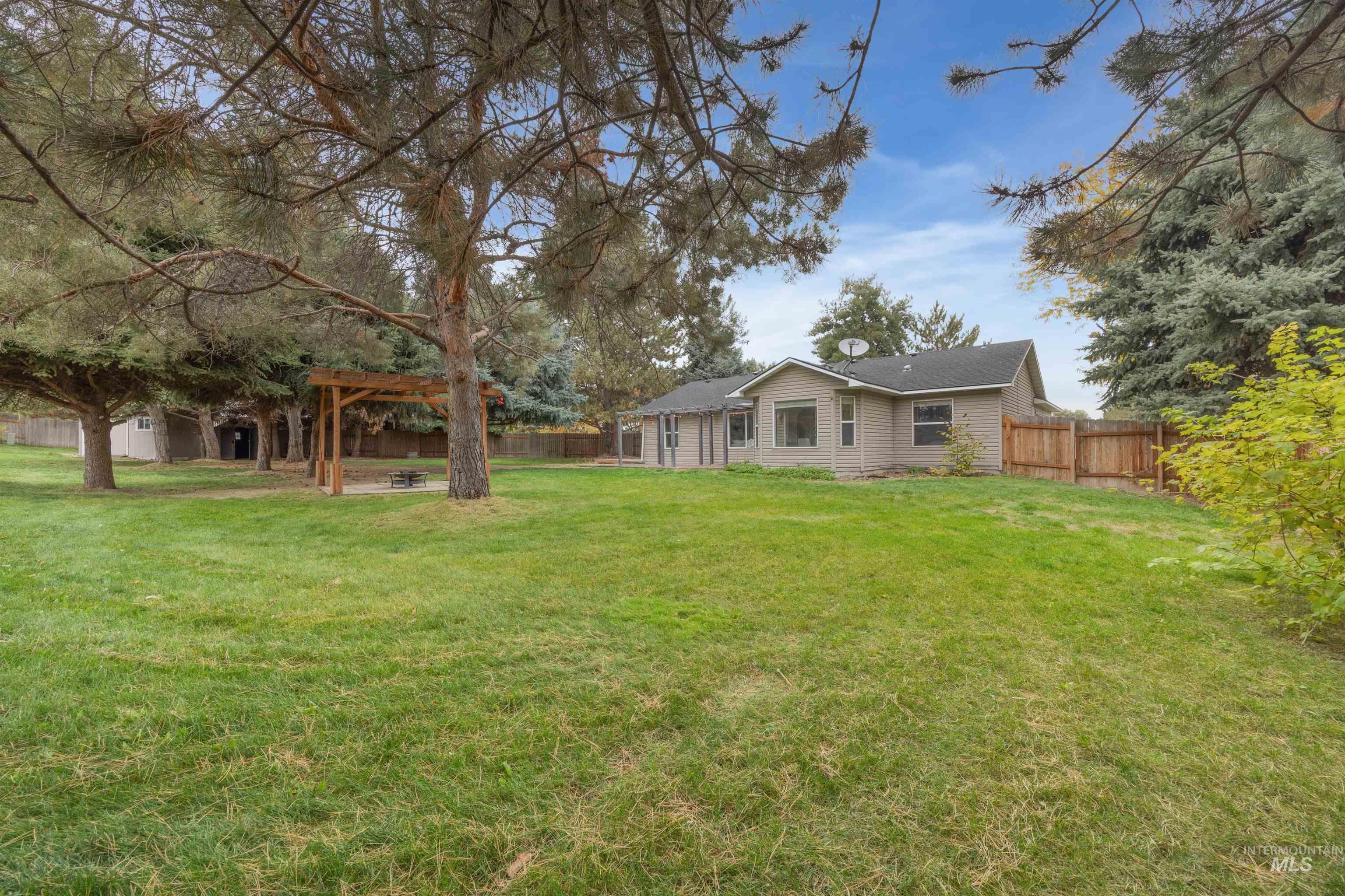 Rear view of property with a fenced backyard and a patio