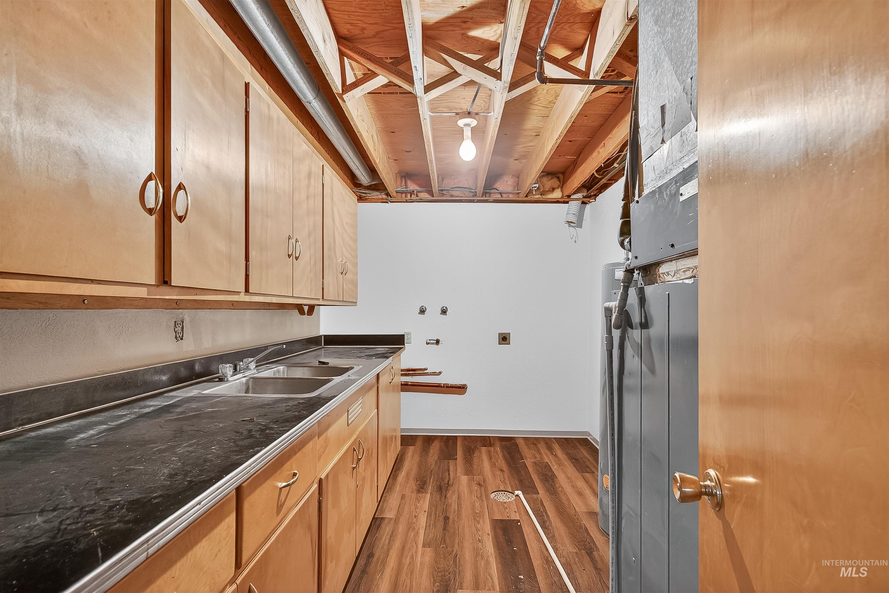 Kitchen with dark wood-style flooring and dark countertops