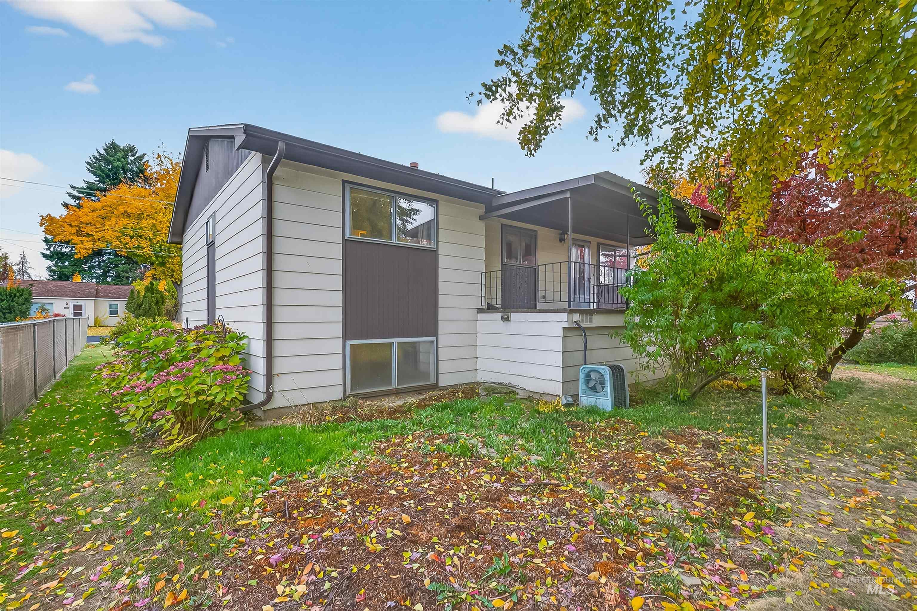 Back of house with a balcony