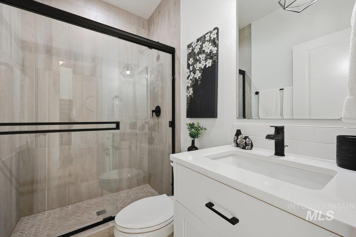 Bathroom with vanity and a stall shower
