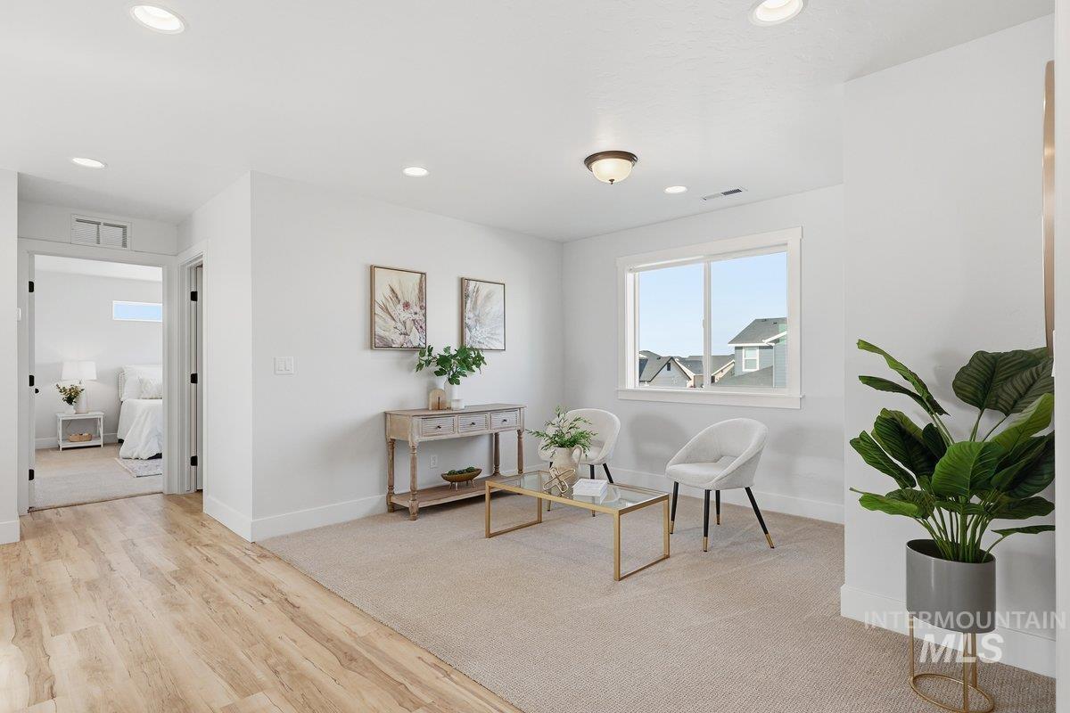 Sitting room with recessed lighting and light wood finished floors