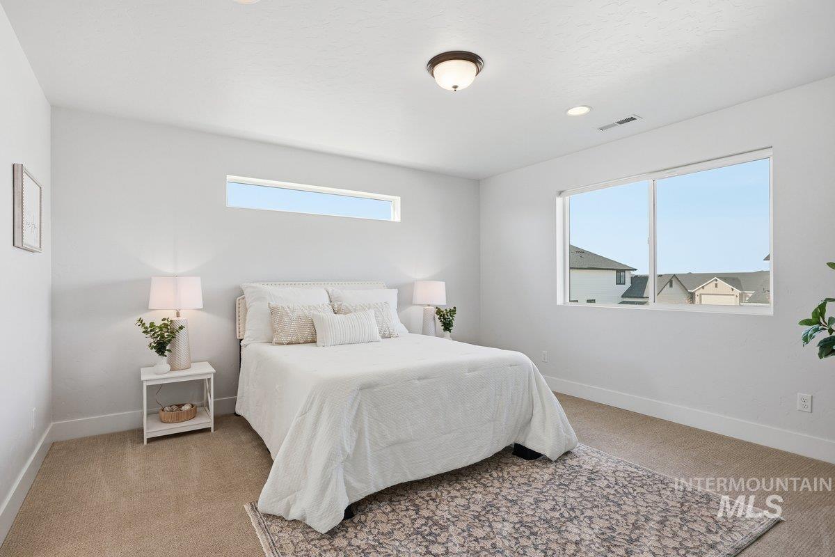 Bedroom featuring light colored carpet and recessed lighting