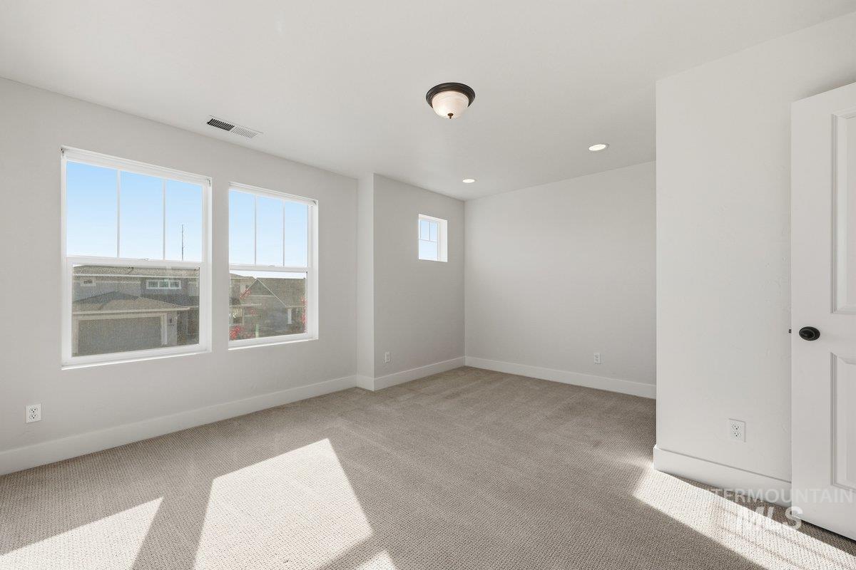 Unfurnished room with light carpet and recessed lighting