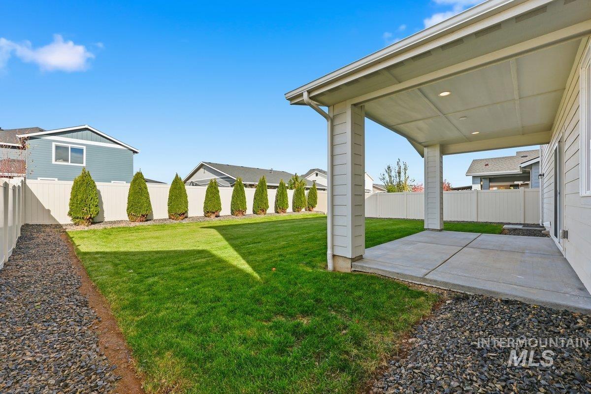 Fenced backyard with a patio area