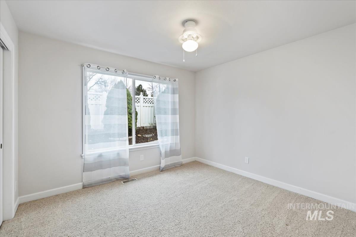 Unfurnished room with carpet floors and baseboards