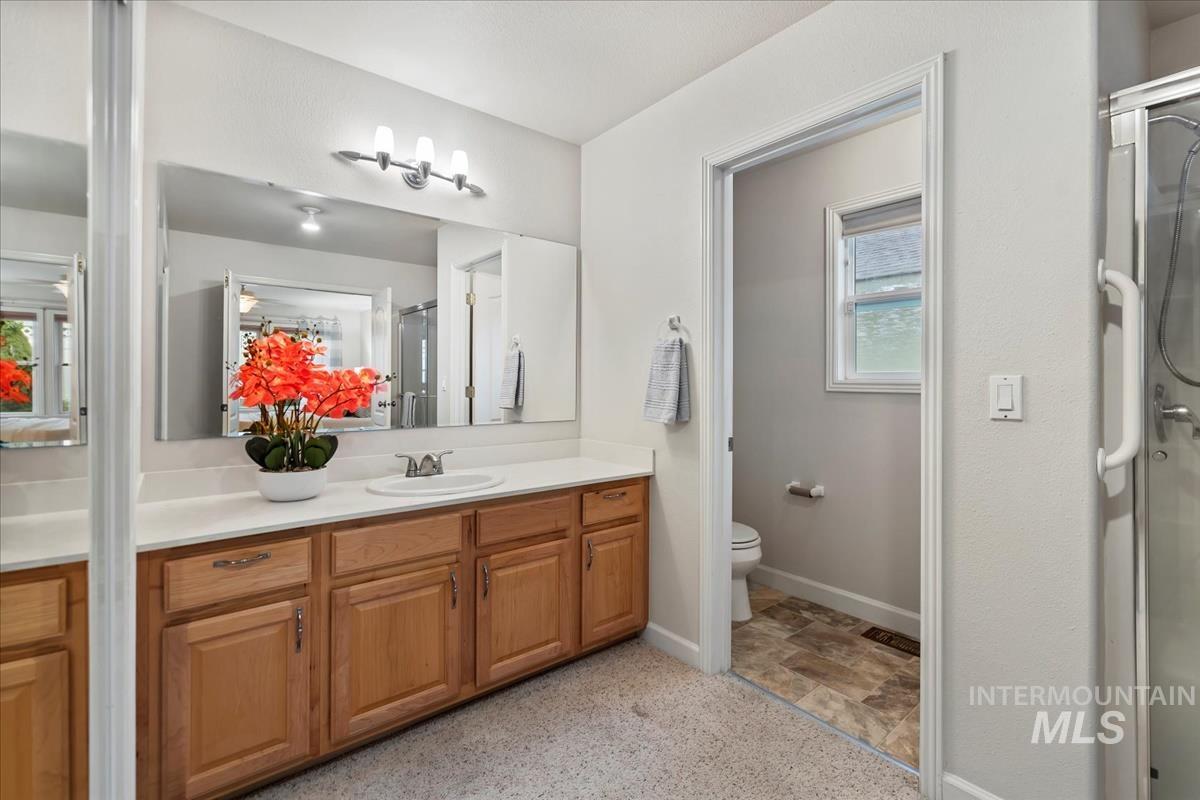Full bathroom featuring vanity and a stall shower