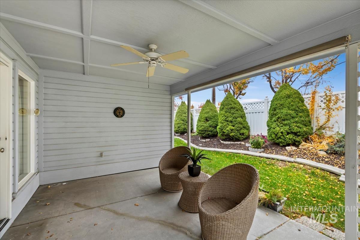 Sunroom featuring a ceiling fan and a patio