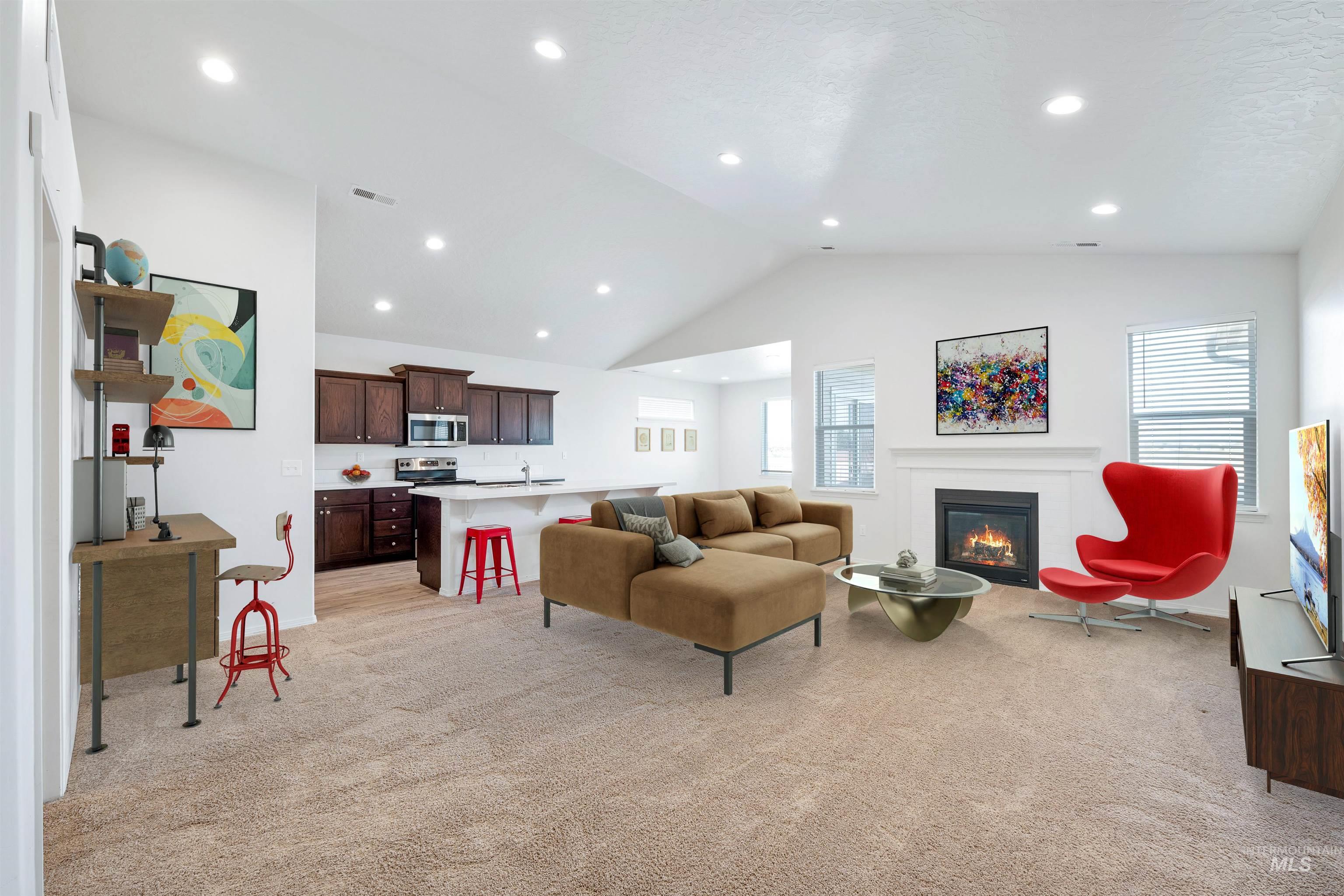 Living room featuring light carpet, recessed lighting, a glass covered fireplace, and high vaulted ceiling