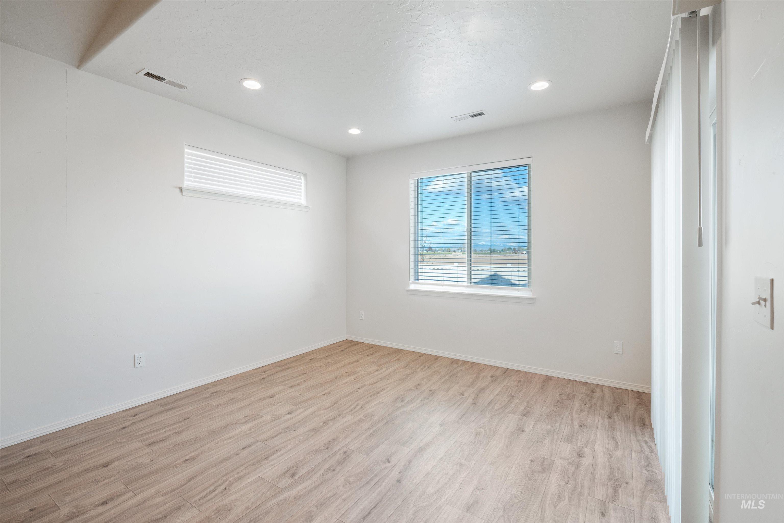 Spare room with light wood-style flooring and recessed lighting