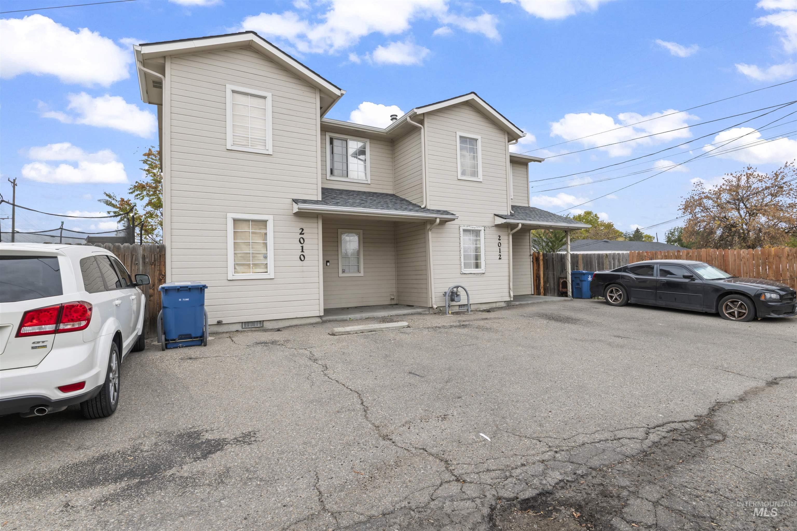 Traditional home featuring roof with shingles