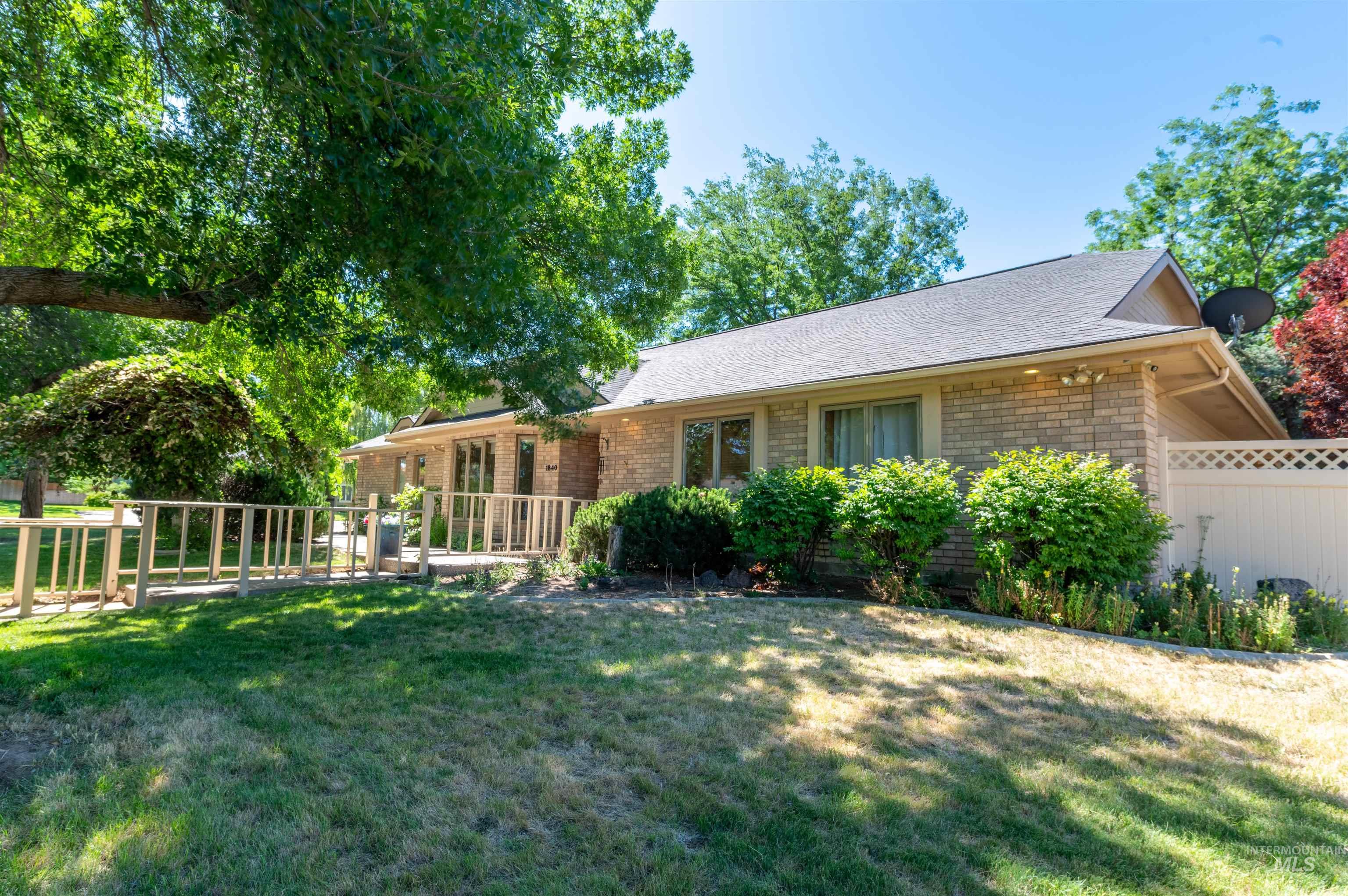 View of front of home featuring brick siding and a shingled roof