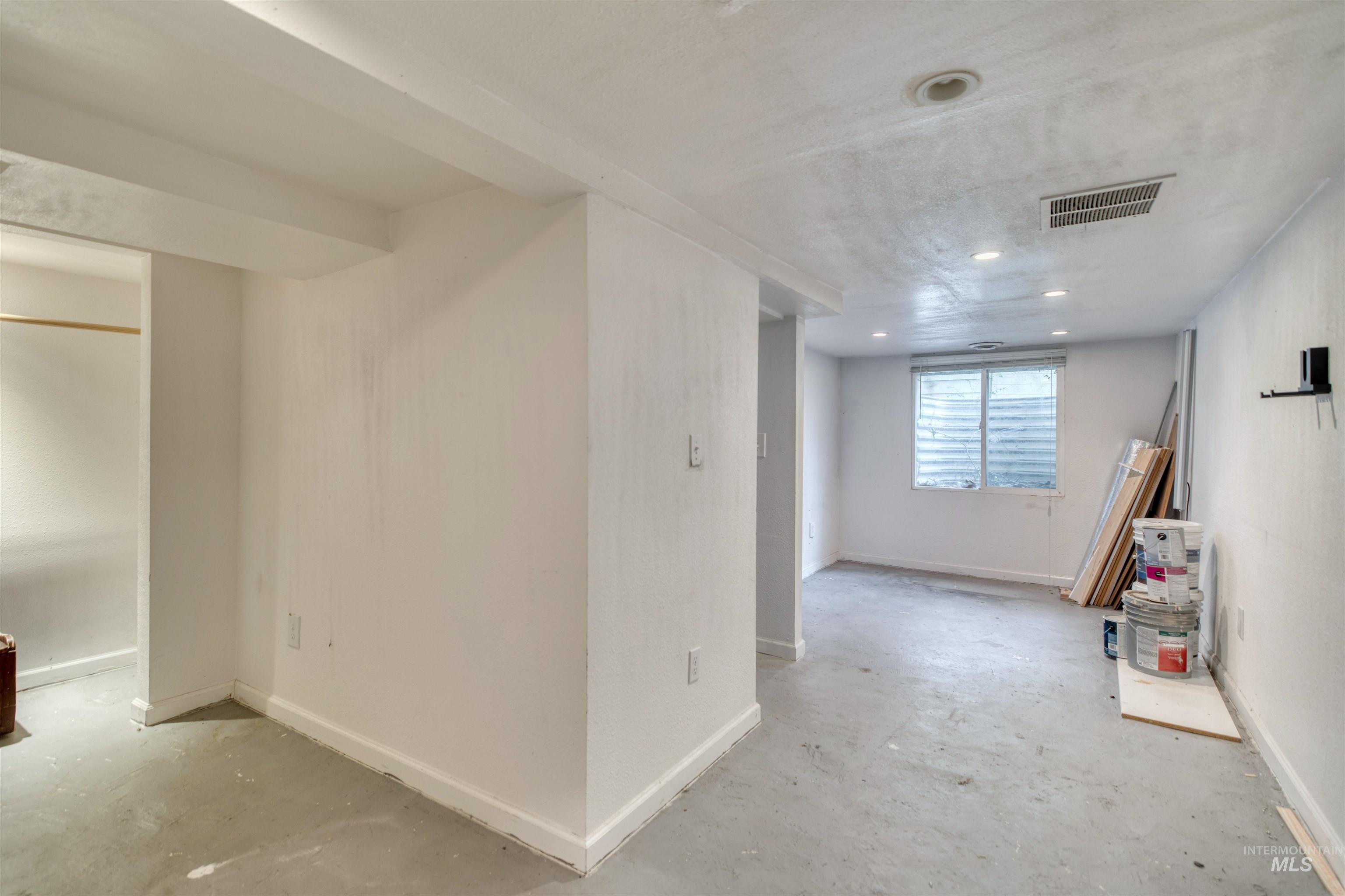 Below grade area featuring baseboards and a textured ceiling