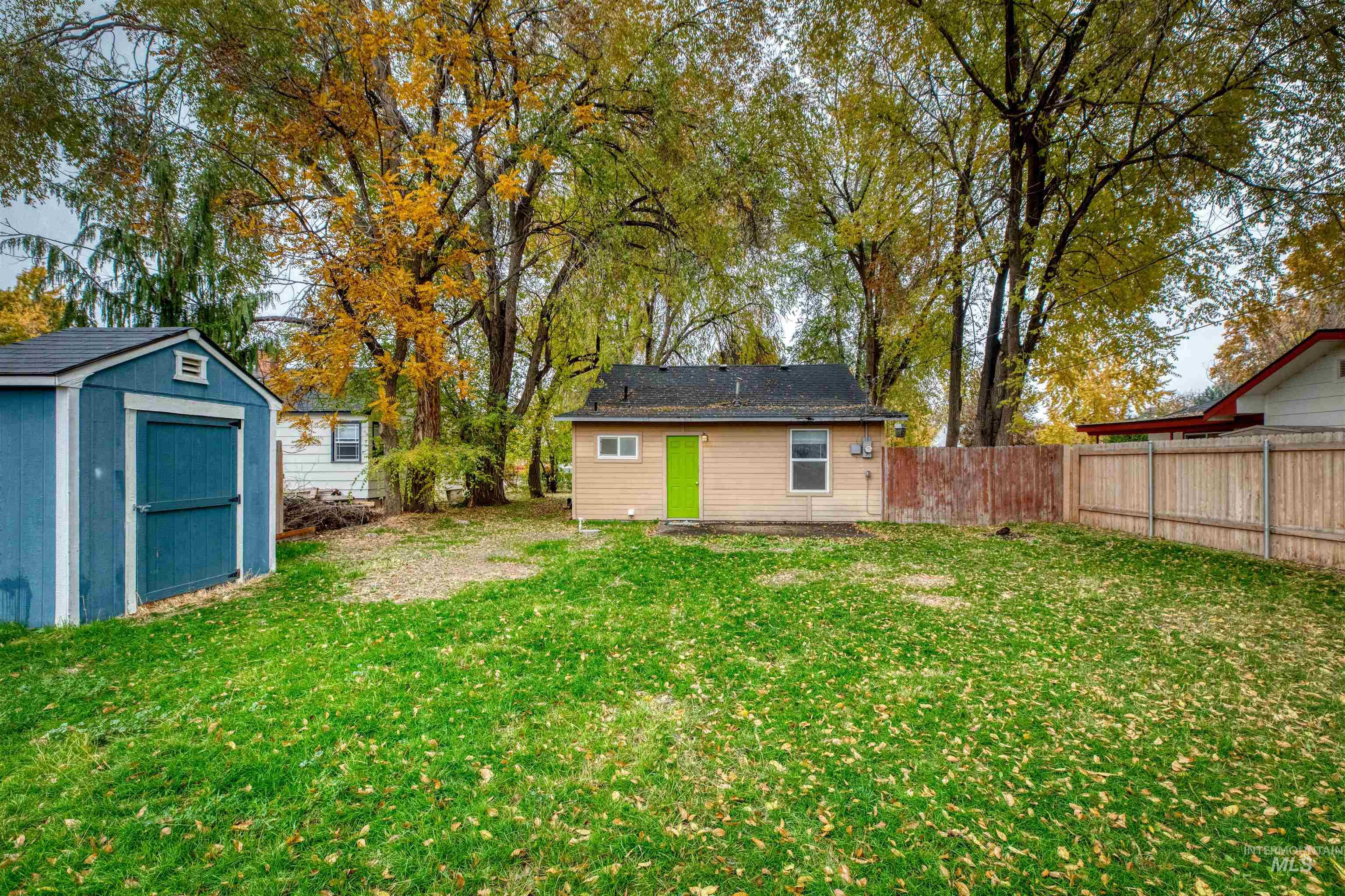 Fenced backyard with a storage shed