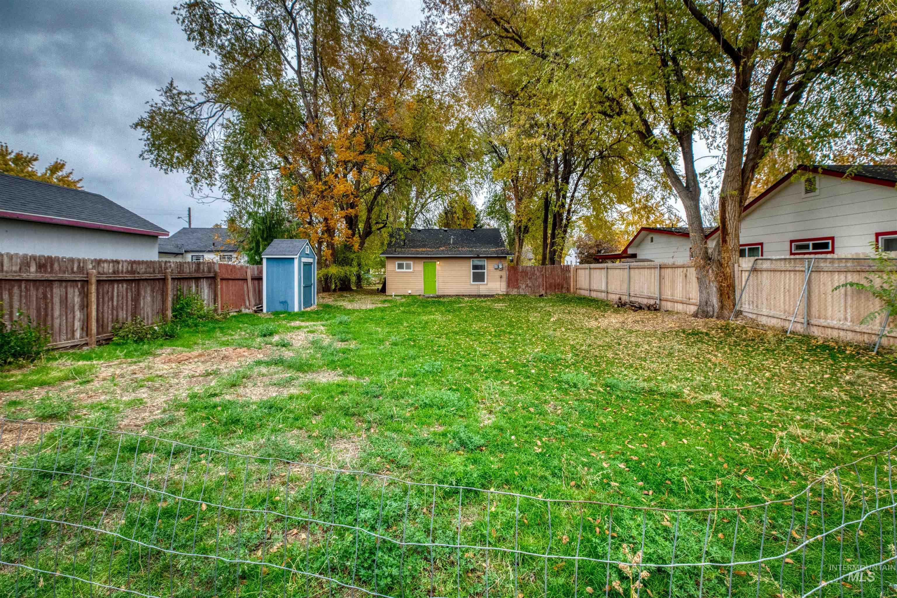 Fenced backyard with a shed