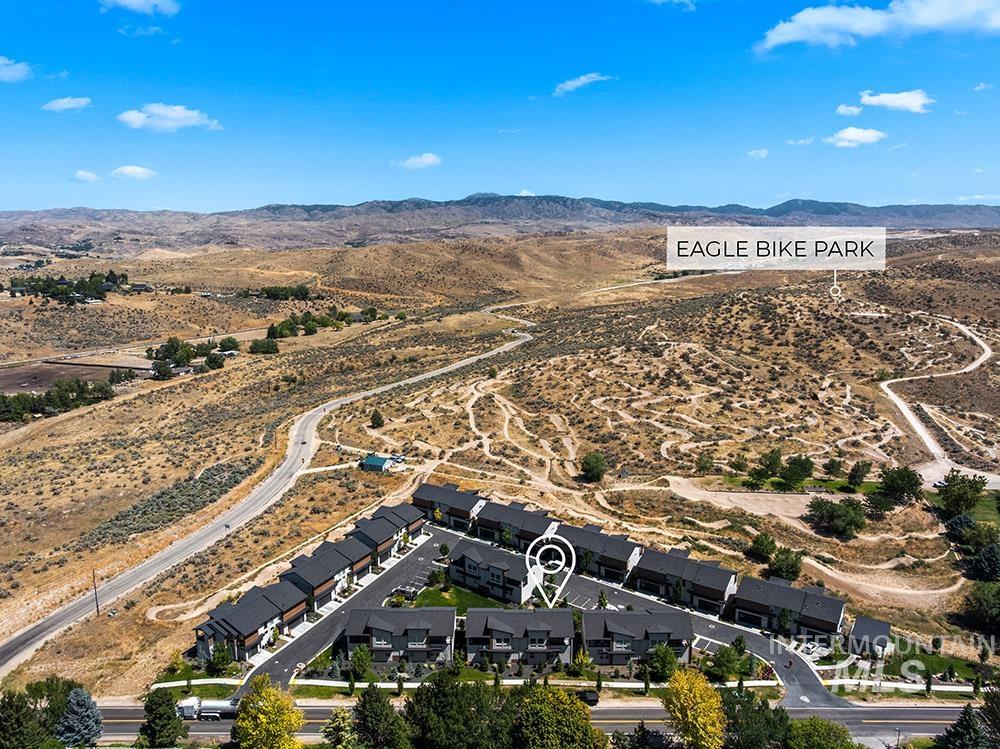 Aerial view of property's location with a mountainous background and rural landscape