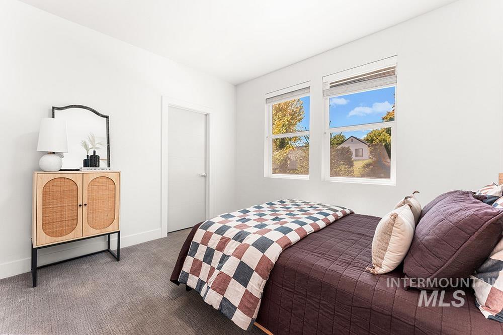 Bedroom with carpet flooring and baseboards