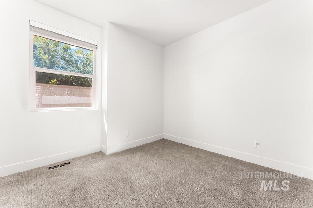 Unfurnished room featuring carpet and baseboards