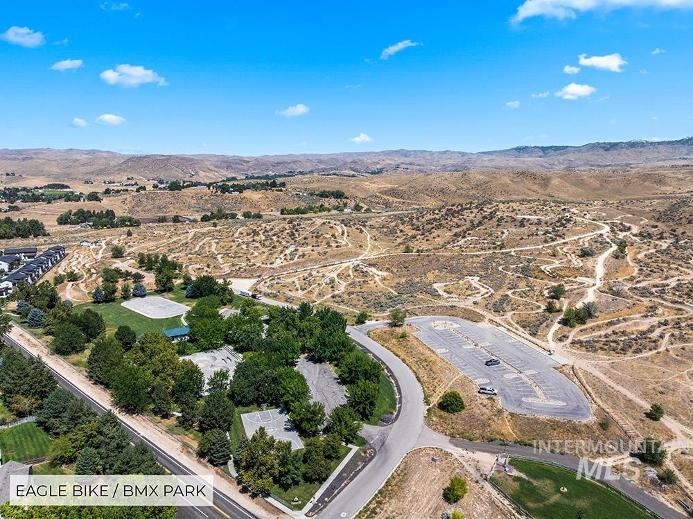 Aerial overview of property's location featuring a mountain backdrop and rural landscape