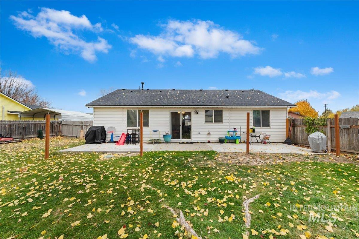 Rear view of property featuring a patio and a fenced backyard