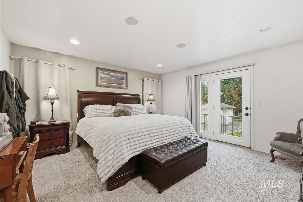 Carpeted bedroom with access to outside and recessed lighting