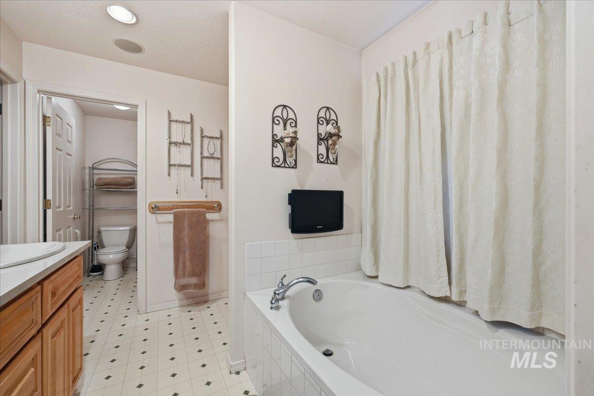 Bathroom featuring vanity and a bath