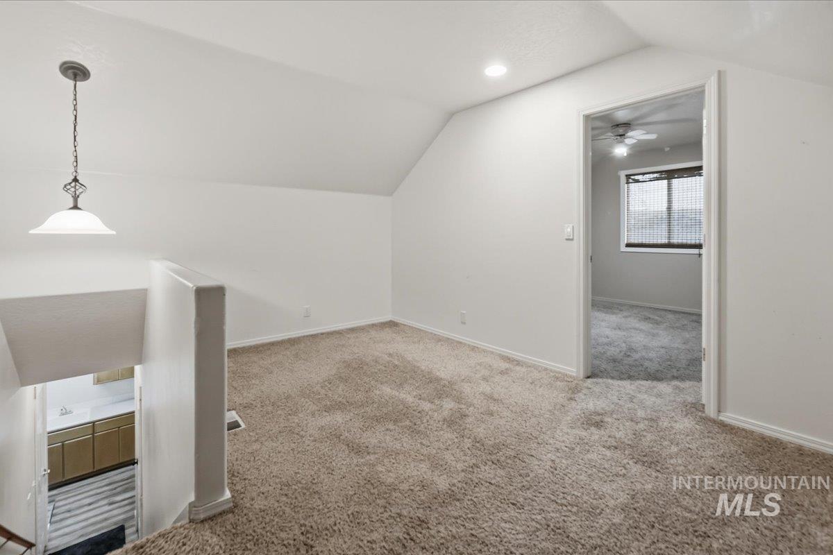 Additional living space with vaulted ceiling, light carpet, and recessed lighting