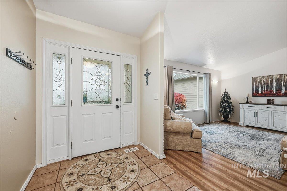 Entryway with light tile patterned floors and healthy amount of natural light