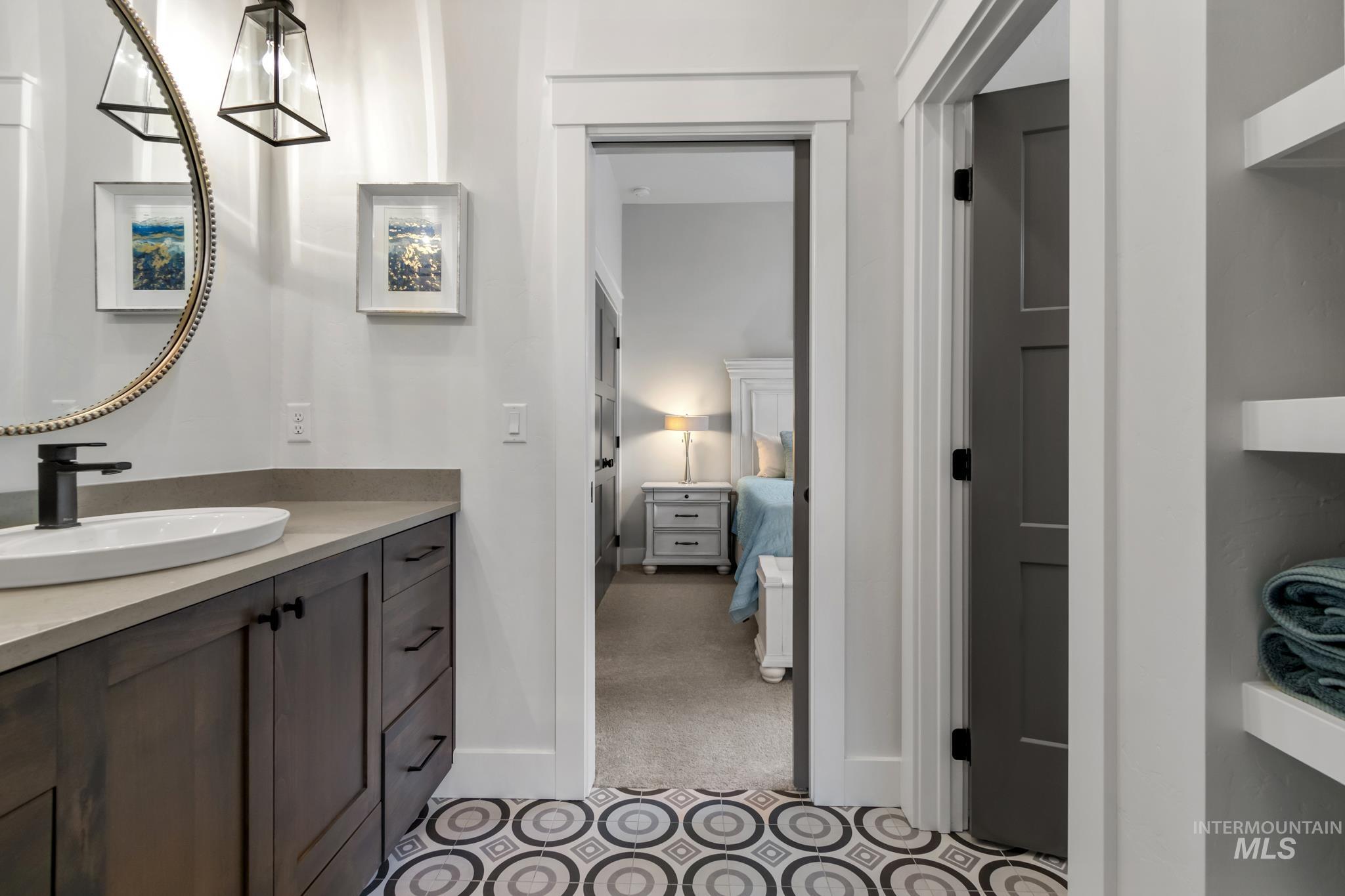 Ensuite bathroom with vanity and light carpet