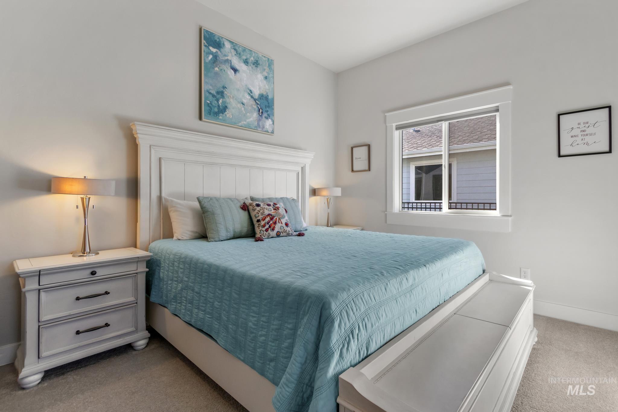 Bedroom featuring baseboards and light carpet