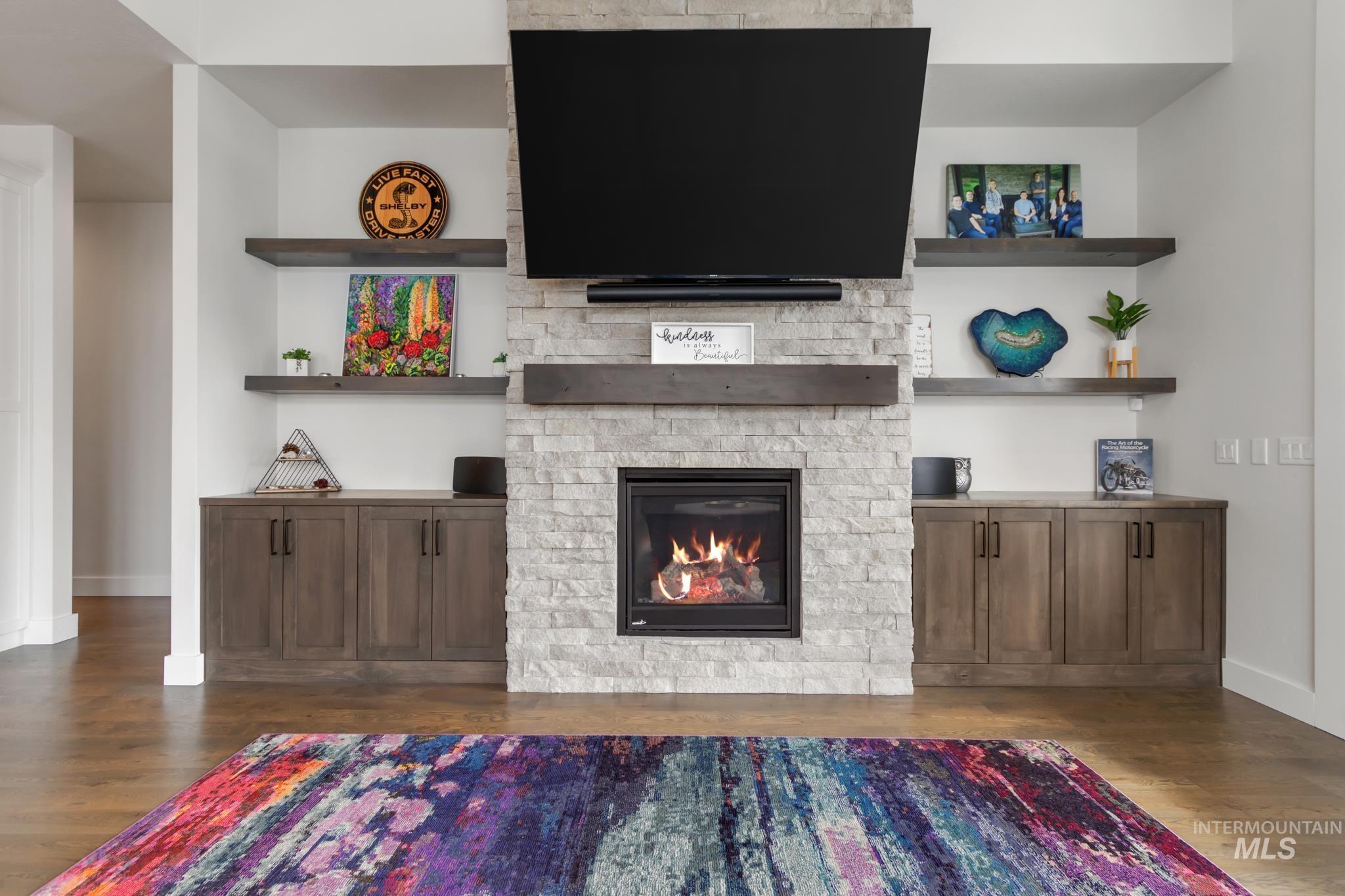 Living room featuring dark wood-style floors and a fireplace