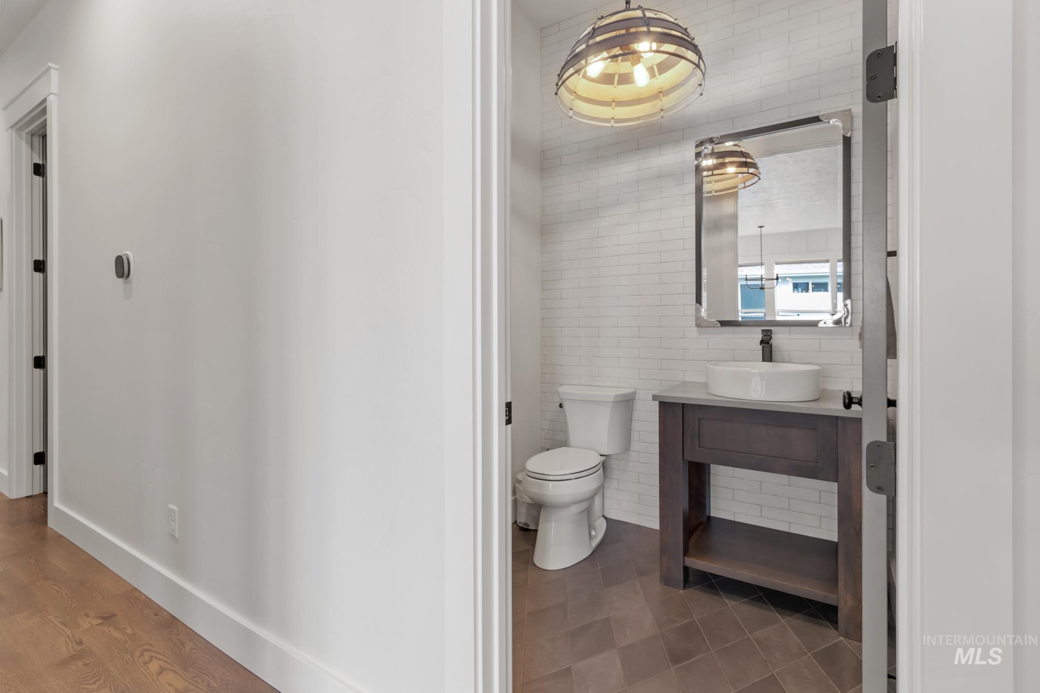 Half bath featuring tile walls and vanity