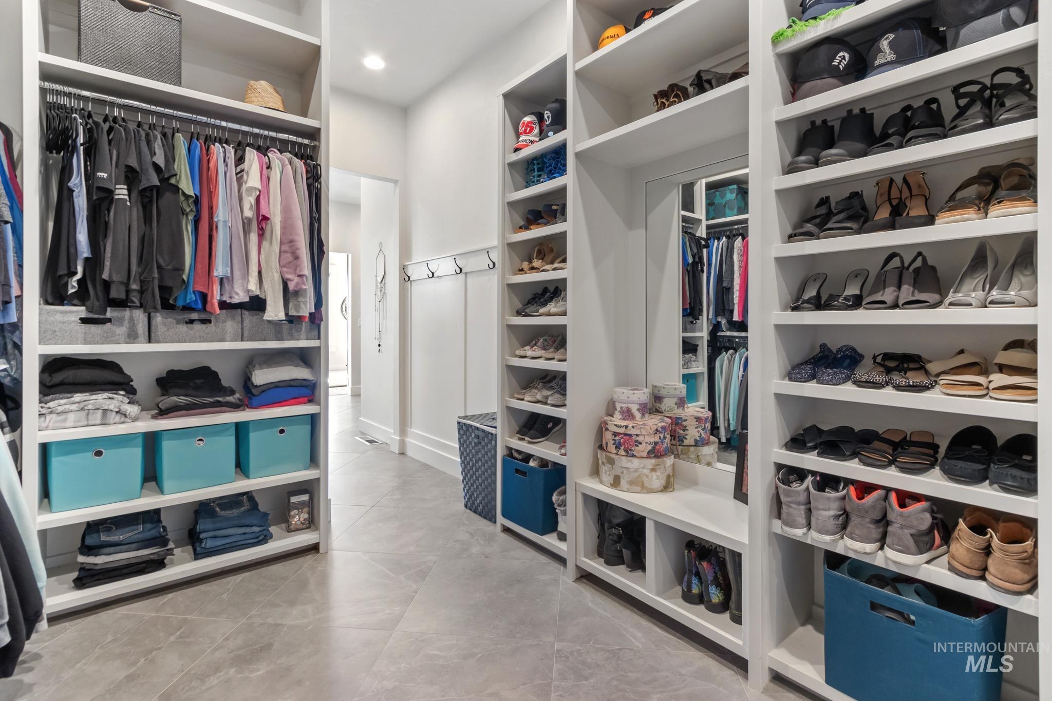 Spacious closet featuring light tile patterned flooring