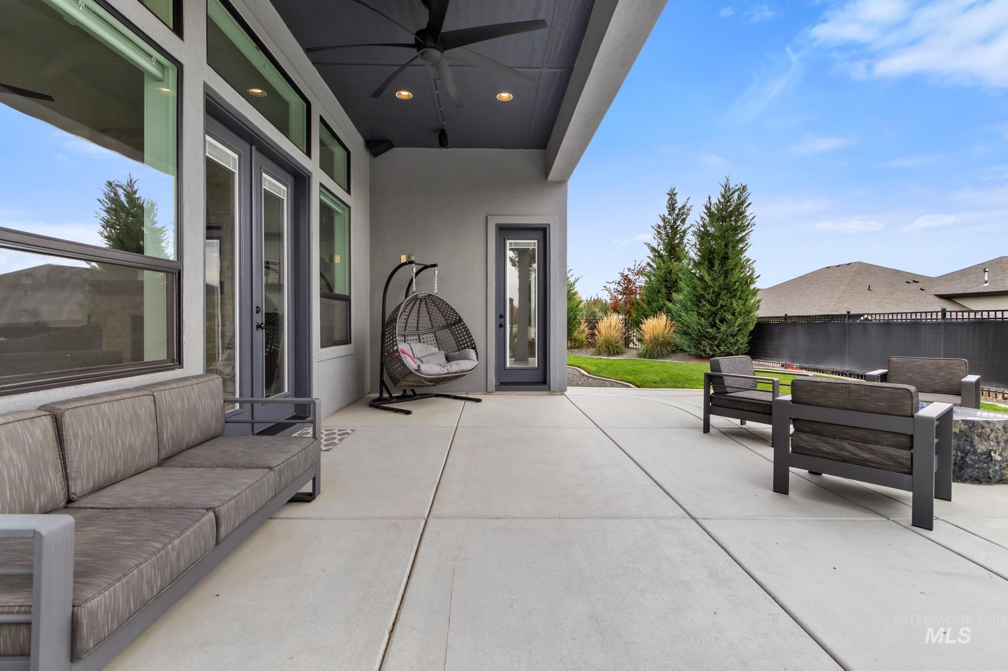 View of patio with an outdoor living space and ceiling fan