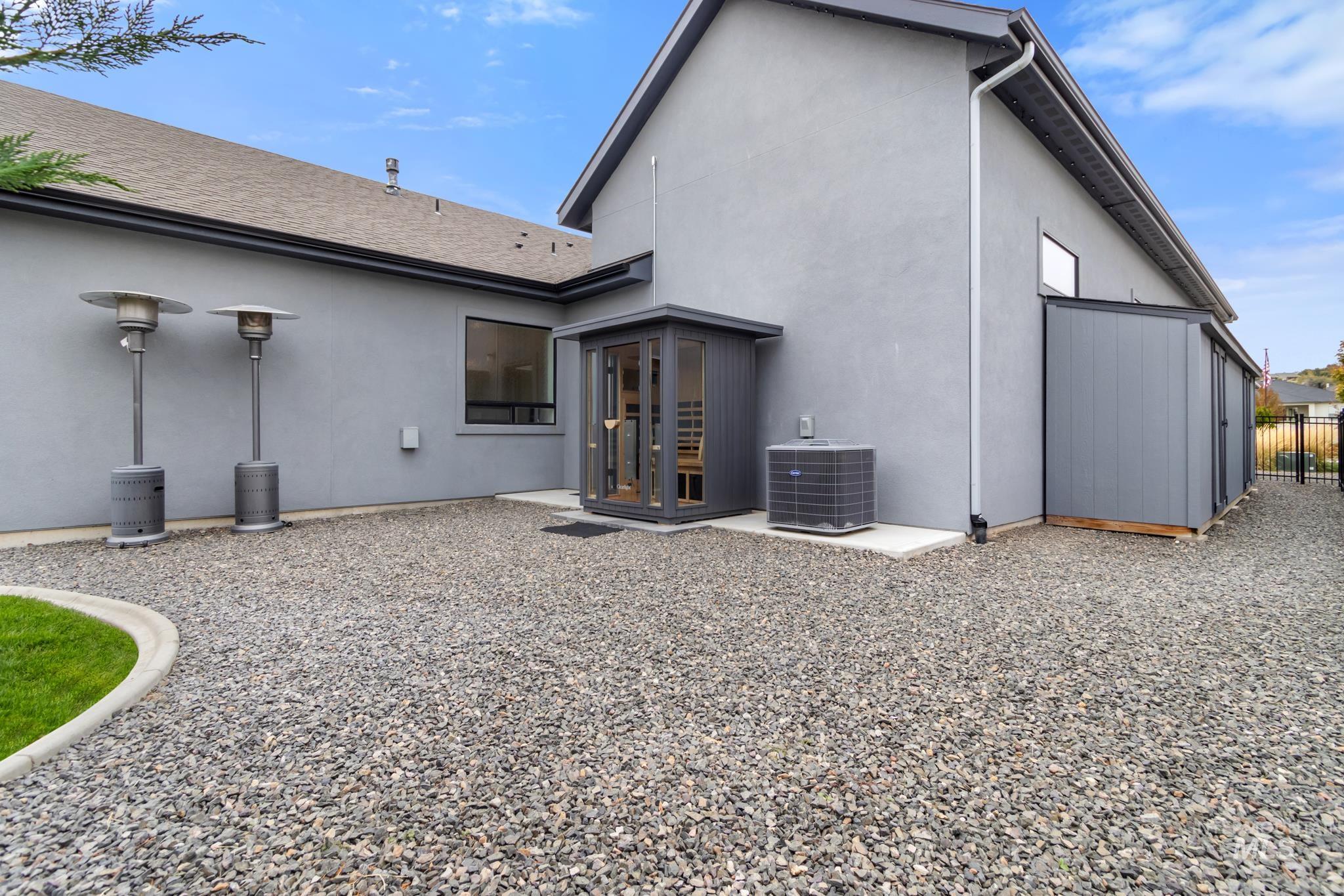 Back of house with stucco siding and a patio