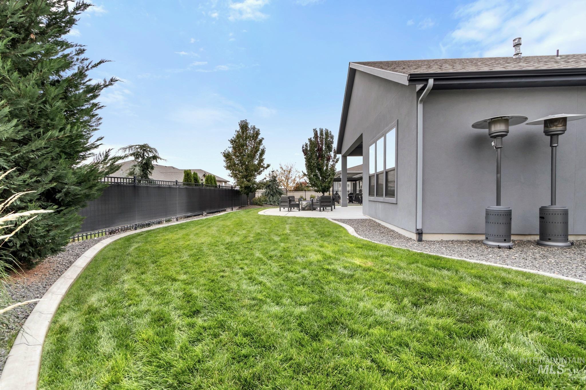 Fenced backyard featuring a patio