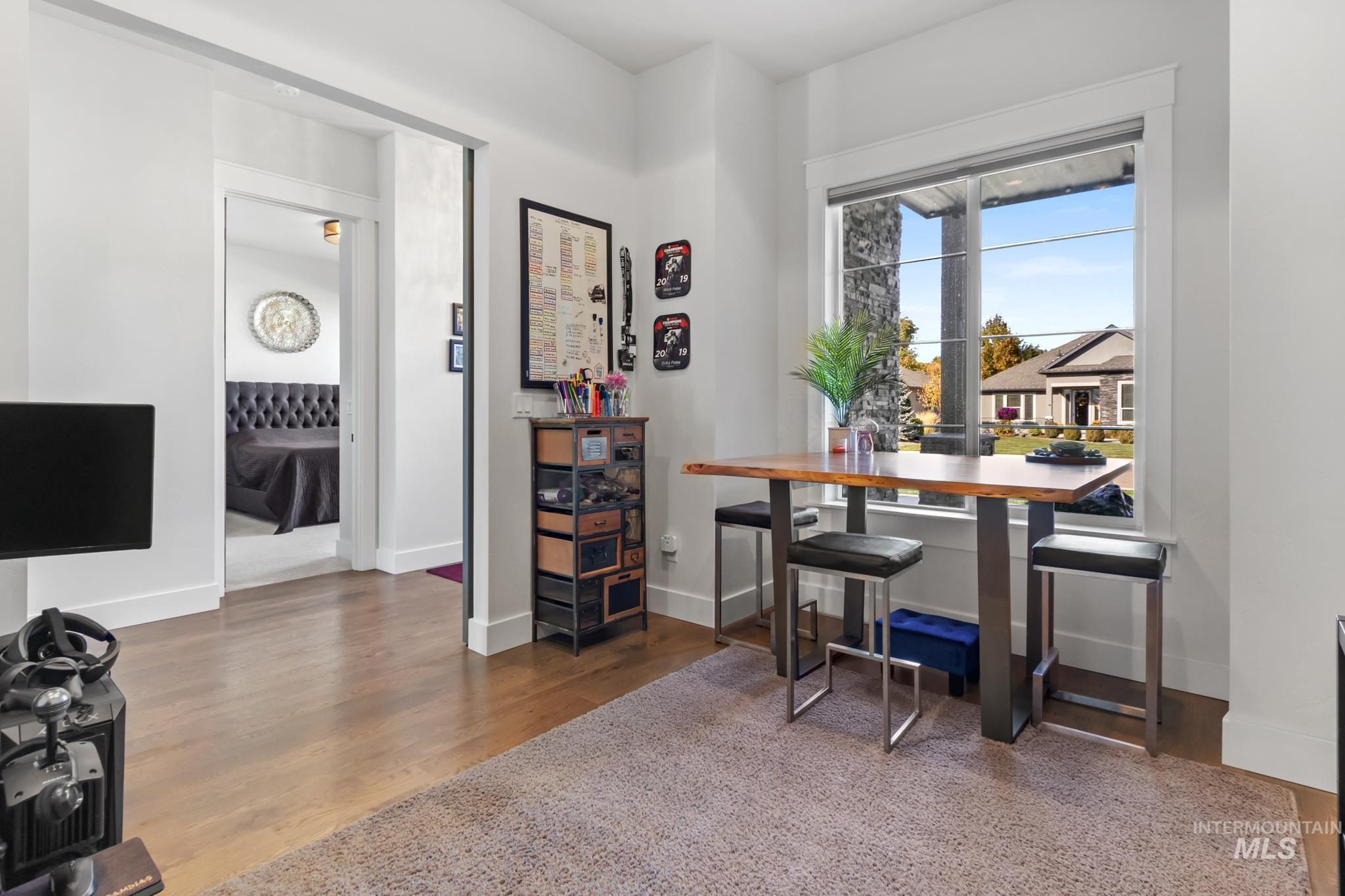 Dining space featuring wood finished floors and baseboards