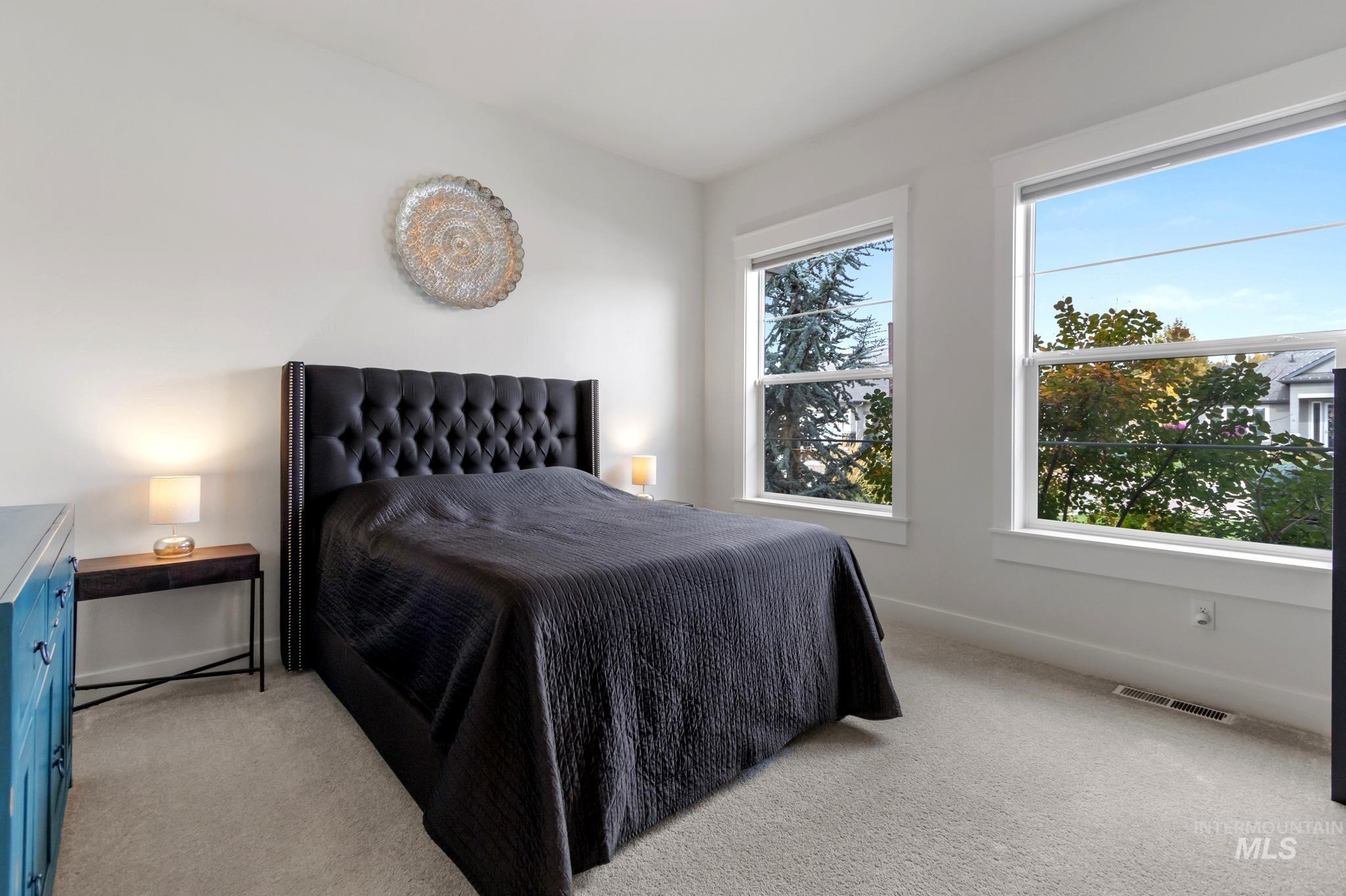 Bedroom featuring light colored carpet and baseboards