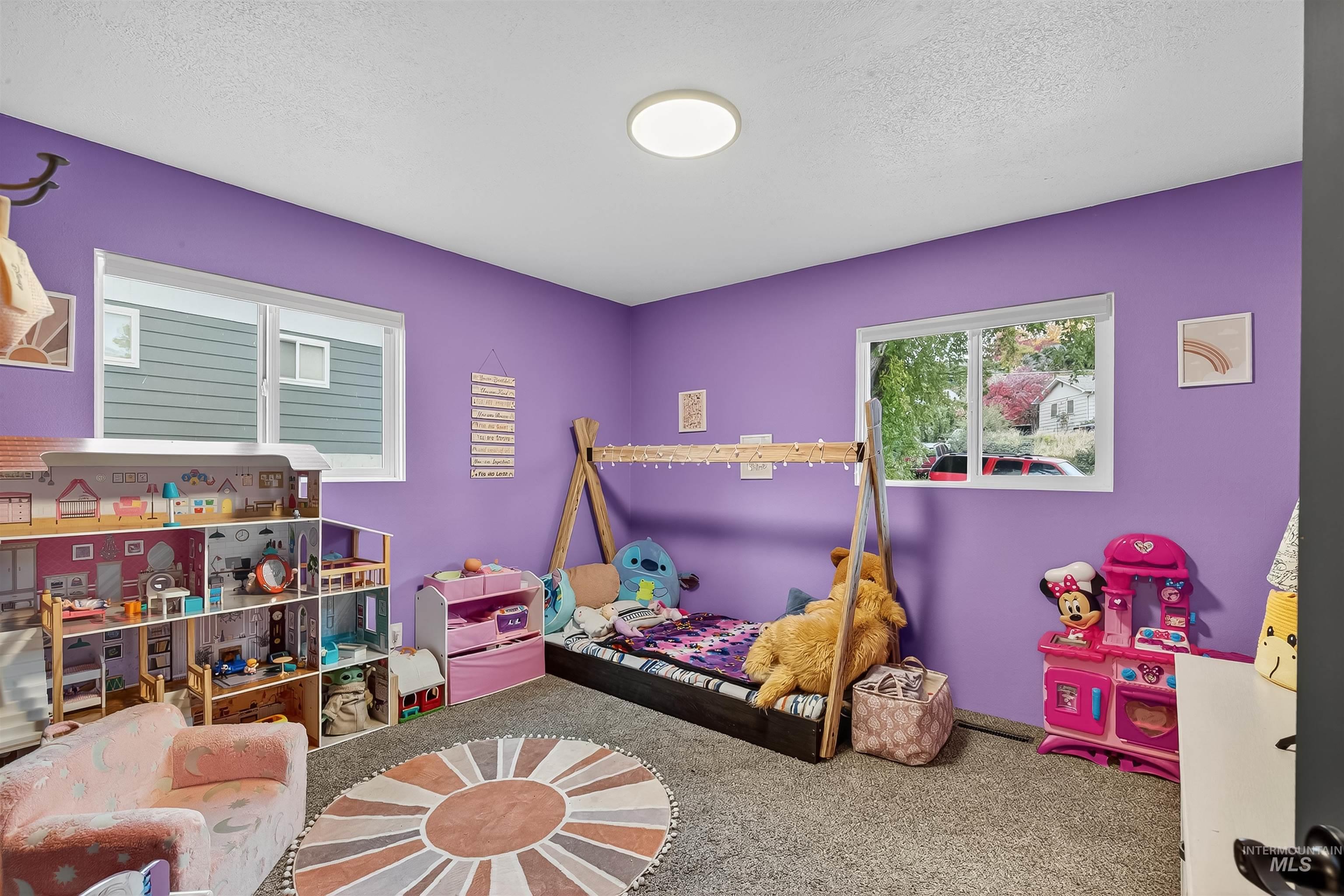 Bedroom featuring carpet flooring and a textured ceiling