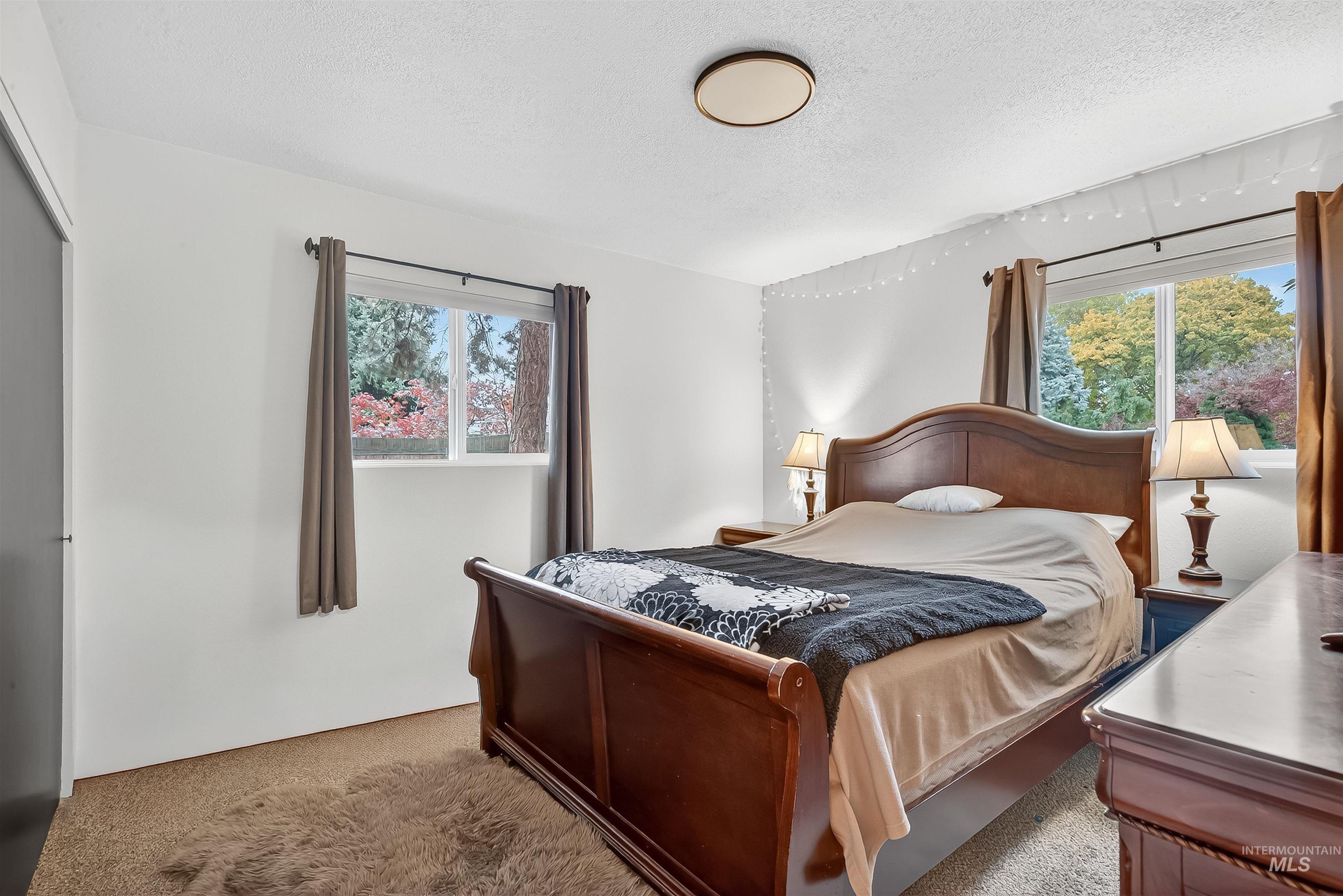 Carpeted bedroom with a textured ceiling
