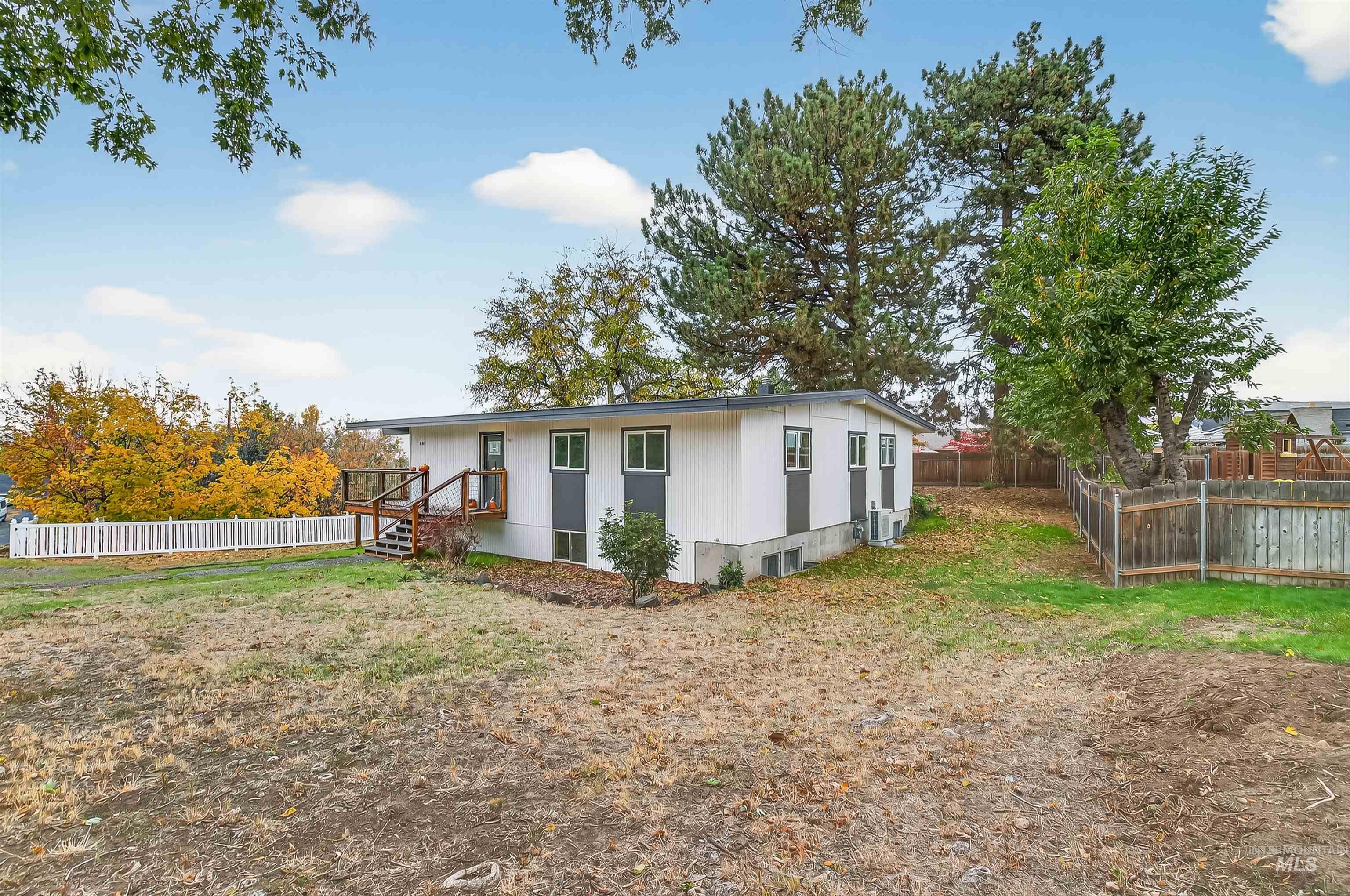 Rear view of house featuring a fenced backyard
