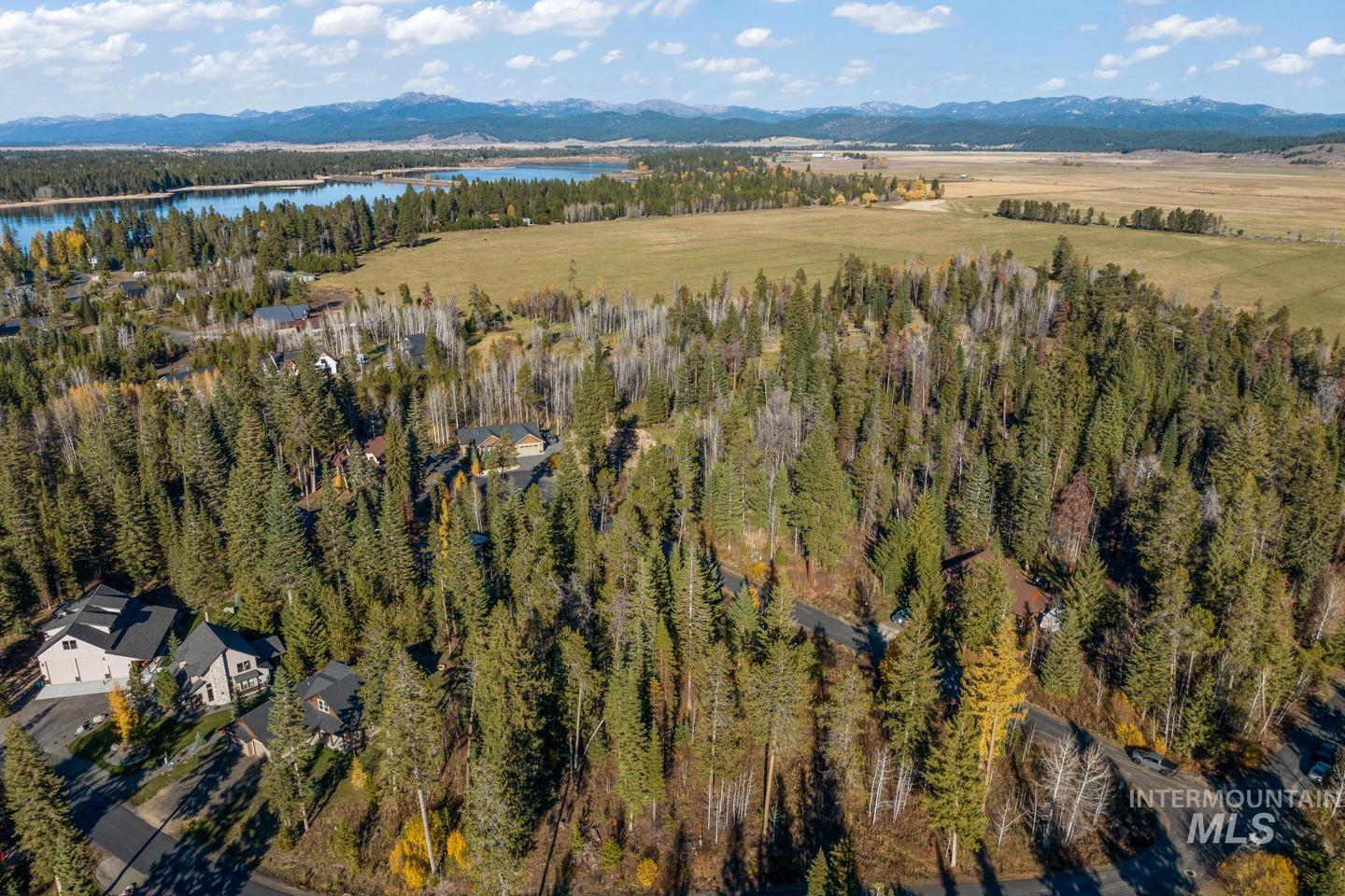 View of property location with a water and mountain view and a heavily wooded area