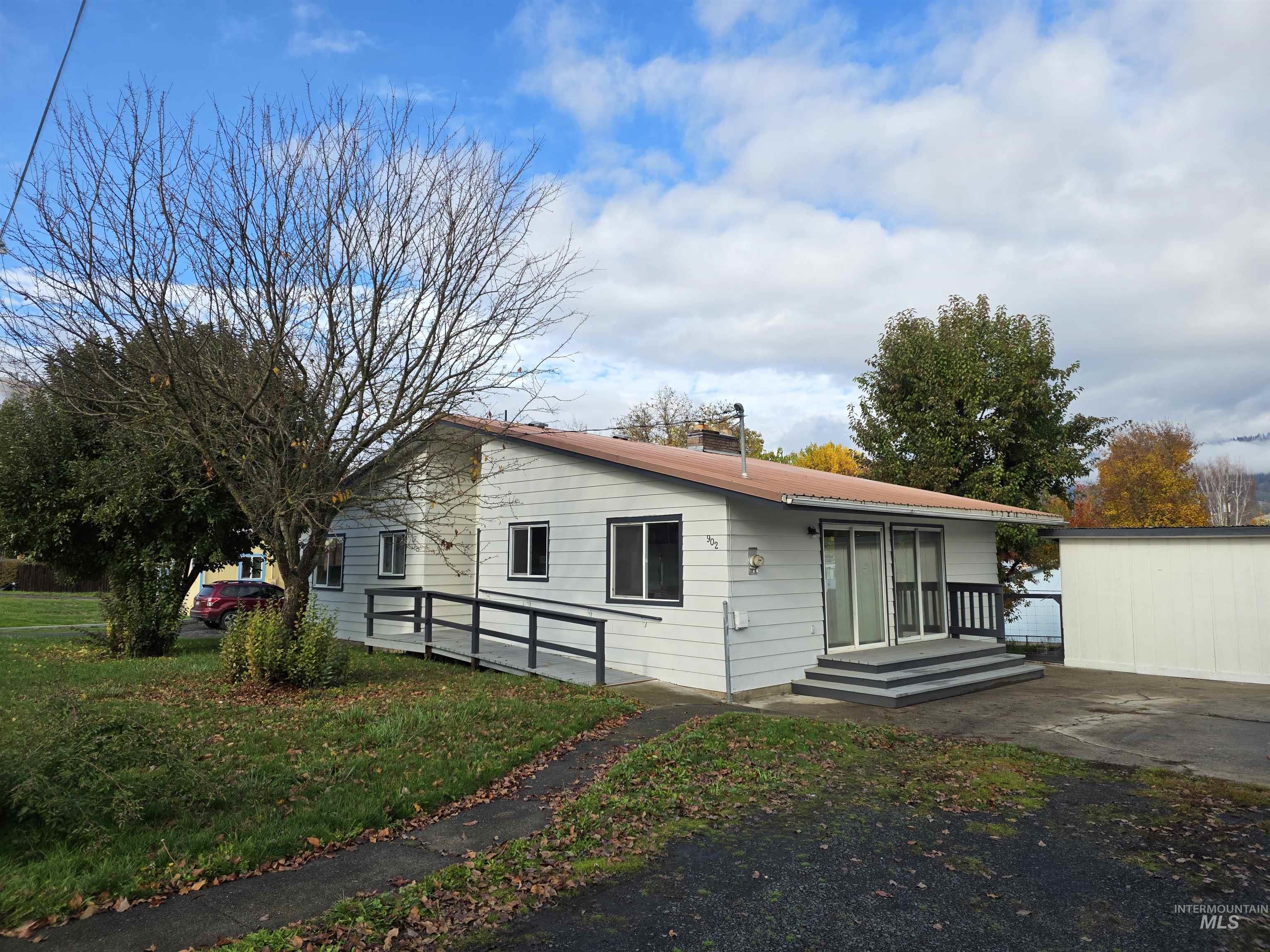 Bungalow-style house with a front yard and a chimney