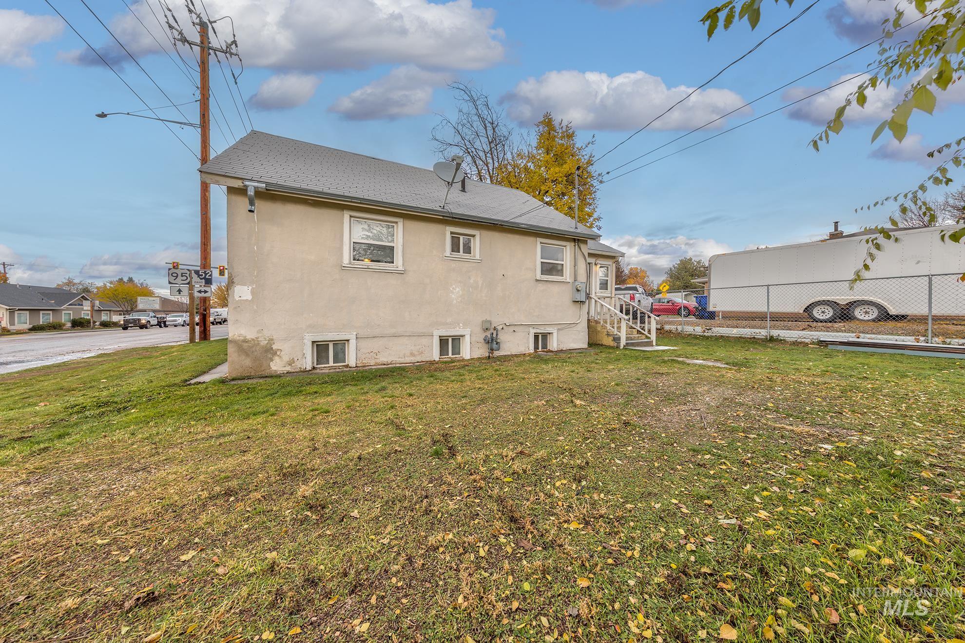 Rear view of property with stucco siding and a shingled roof