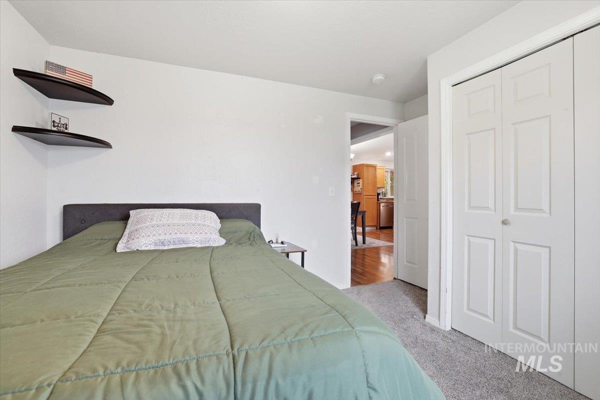 Bedroom featuring carpet and a closet