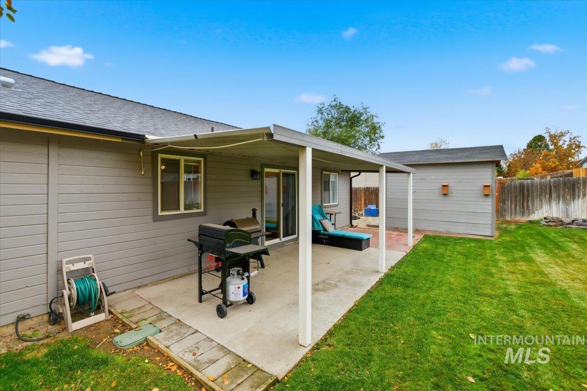 Rear view of house with a patio and an outdoor structure