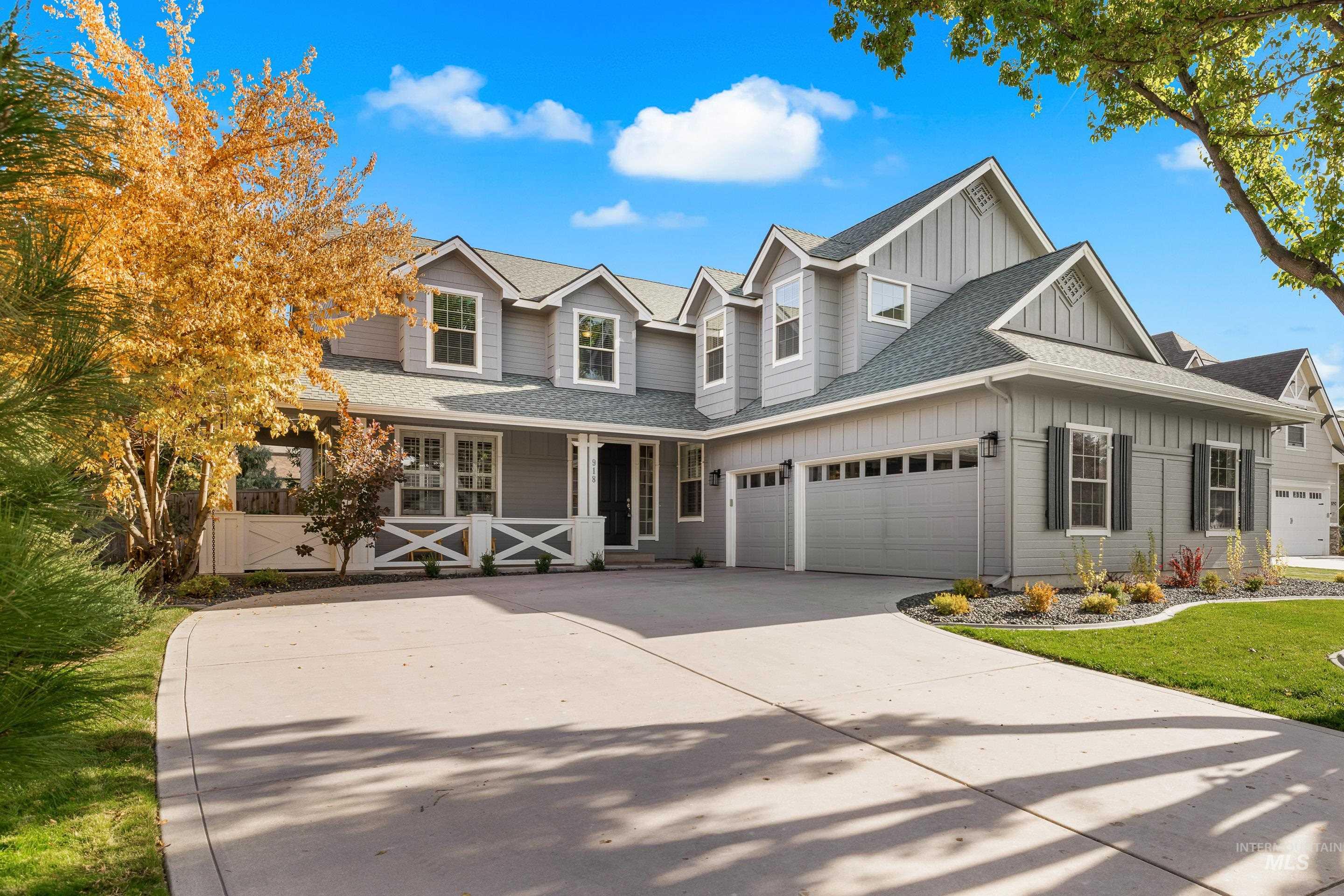 View of front of home with board and batten siding, roof with shingles, driveway, a garage, and a porch