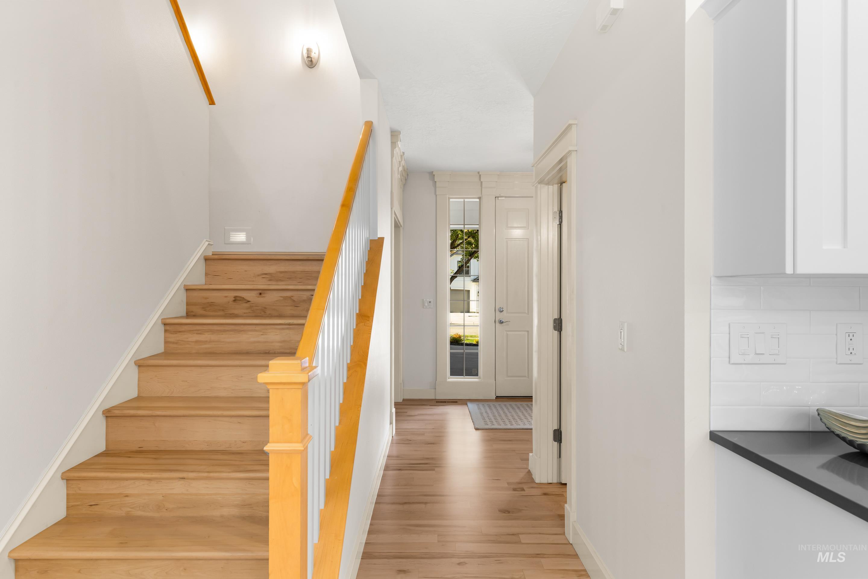 Stairs featuring baseboards and wood finished floors